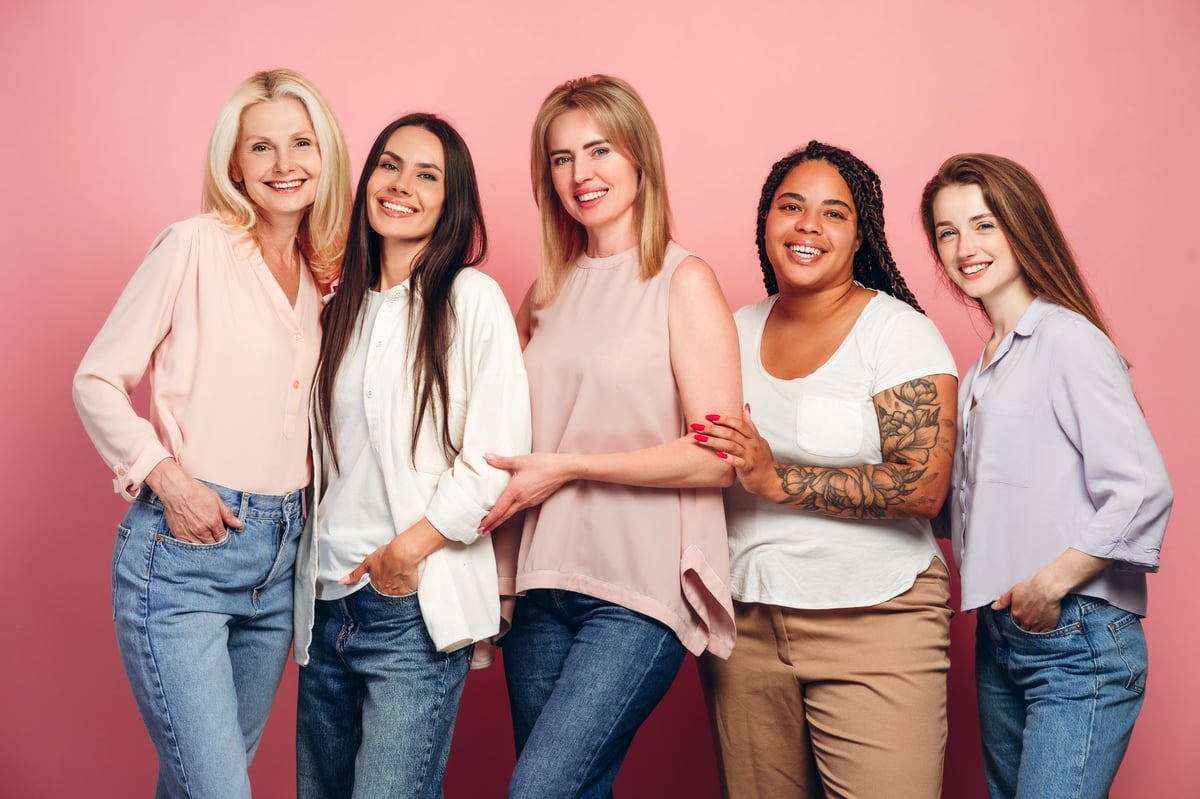 Five women of different ages and backgrounds standing together, celebrating diversity and strength